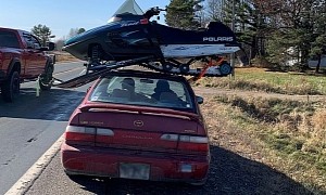 If It Fits, It Ships: Toyota Corolla Hauls Snowmobile on the Roof