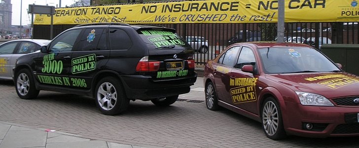 Uninsured cars seized by the Merseyside Police on display outside the police headquarters in May 2006