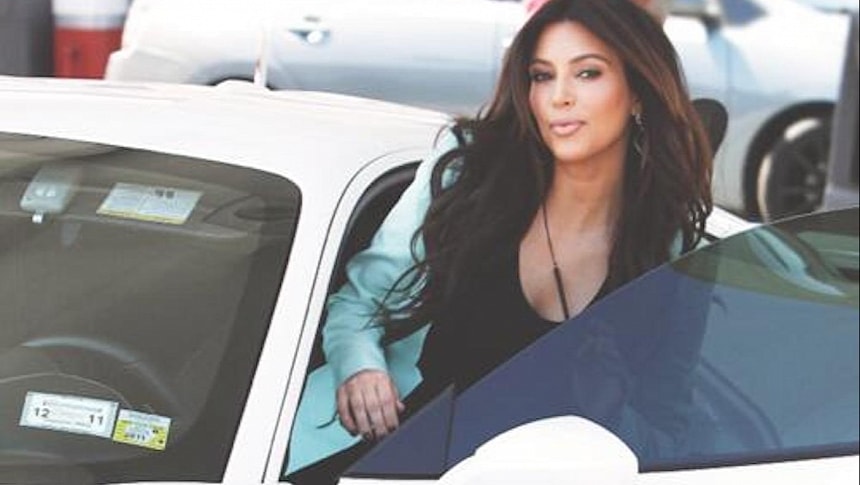 Kim Kardashian driving her white Ferrari over a decade ago