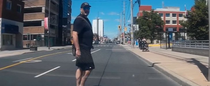 Jaywalker stares down driver, is about to get instant karma for it