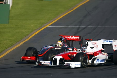 Lewis Hamilton battles Toyota's Jarno Trulli for position
