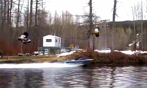 Just Two Snowmobiles Casually Jumping Over a Boat