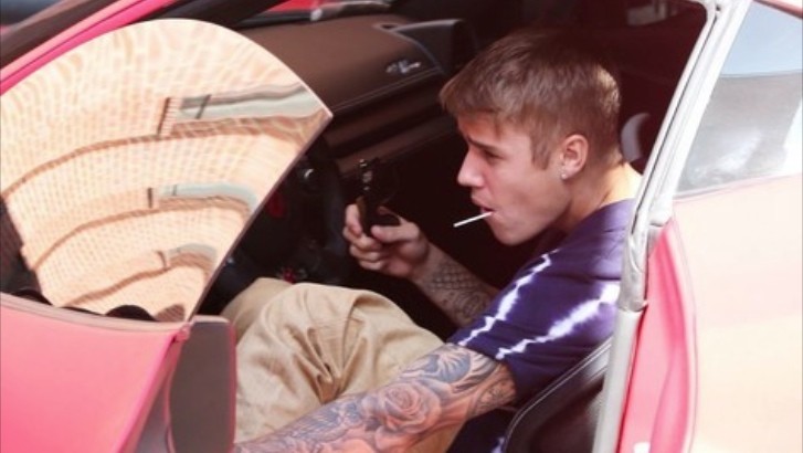 Justin Bieber Sucks on a Lollipop While Driving His Bright Red Ferrari 