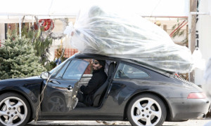 Keanu Reeves Straps Christmas Tree to His Porsche