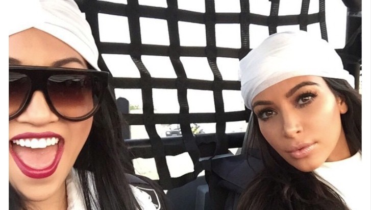 Kim Kardashian and her assistant racing a dune buggy