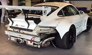 Liberty Walk Porsche 997 GT3 with Fi Exhaust Exiting a Showroom: Lion in a Cage