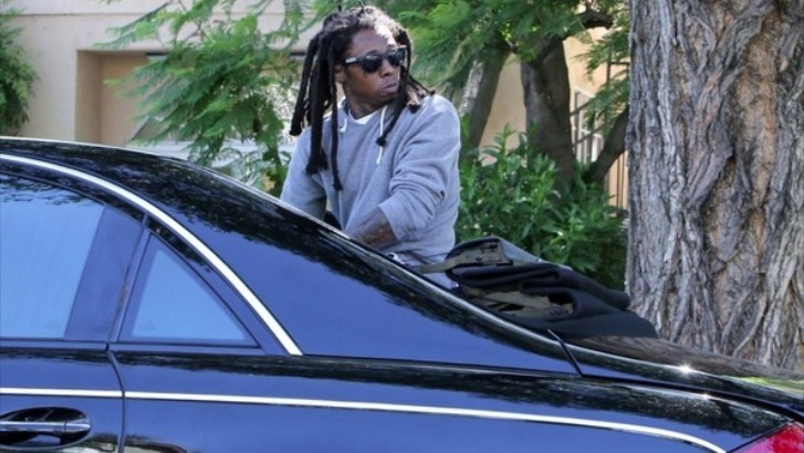 Lil Wayne Rides on the Back Seat of His Maybach Landaulet