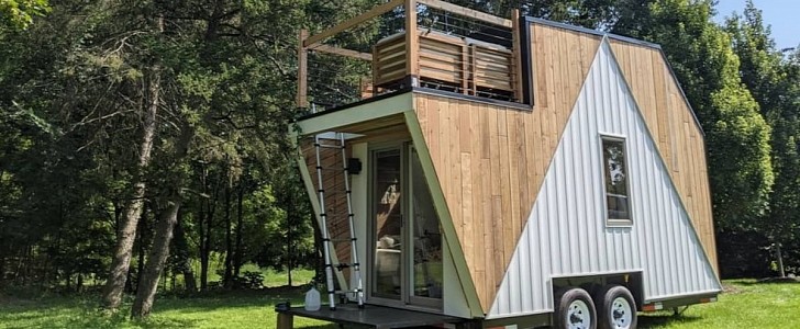 This lovely tiny home in the Lakes Region boasts a welcoming rooftop deck and a large skylounge