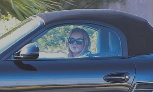 Lindsay Lohan Smokes While Driving a Porsche