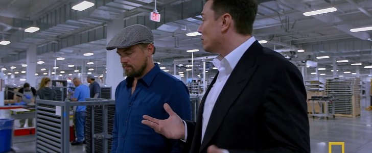 Musk and DiCaprio talking inside the Gigafactory