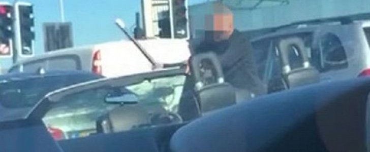 Middle-aged man takes baseball bat to his own BMW convertible while stuck in London traffic