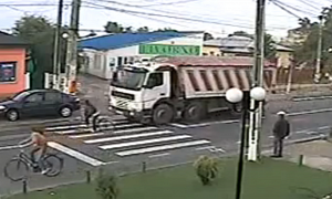Lucky Bicyclist Avoids Being Run Over by Truck