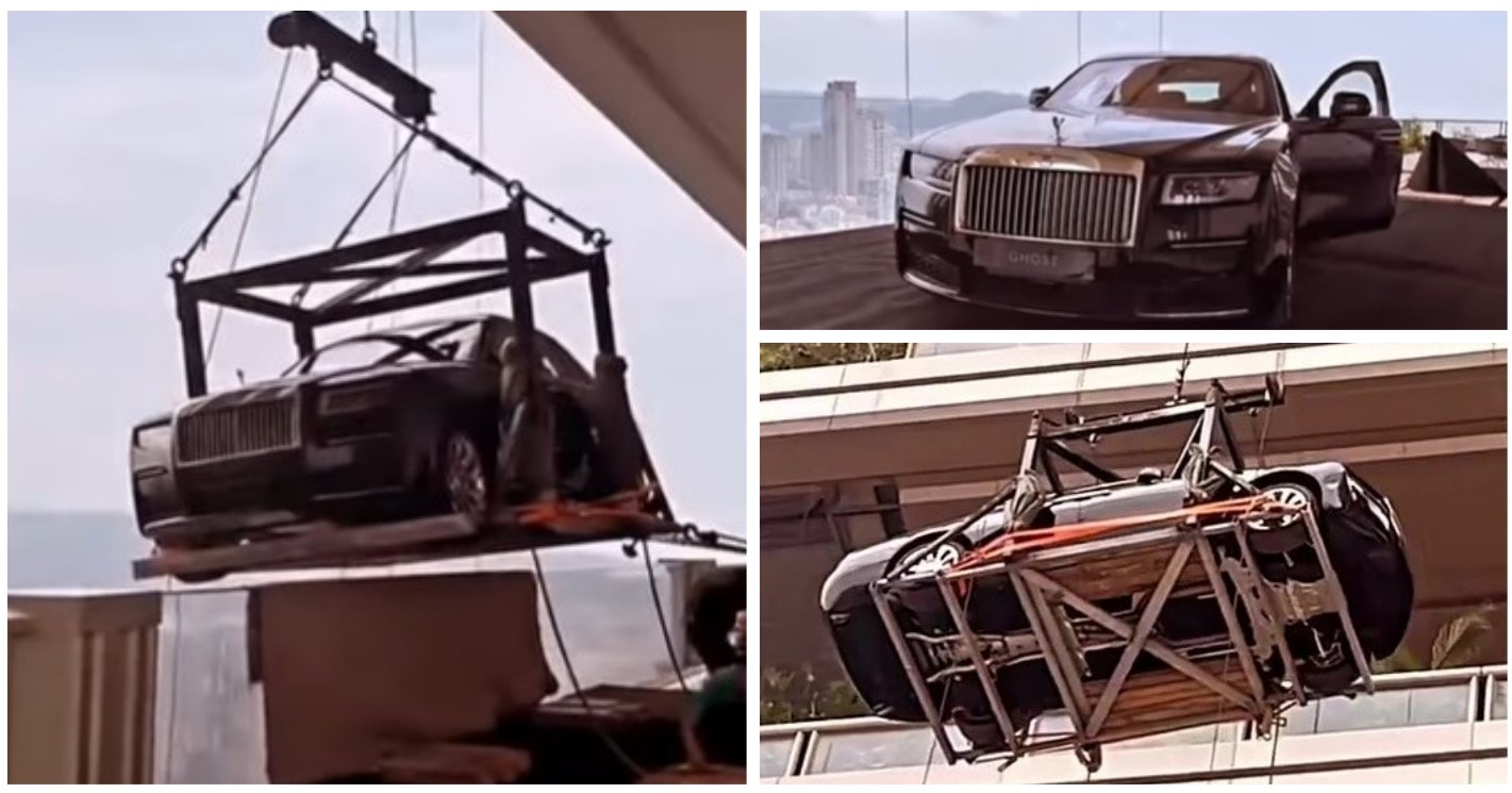 A brand new Rolls-Royce Ghost is hoisted by crane to the 44th floor to be used as a static display on an apartment terrace