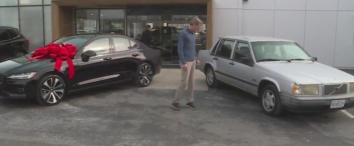 Jim O'Shea in front of Volvo dealership with his old car and his new ride