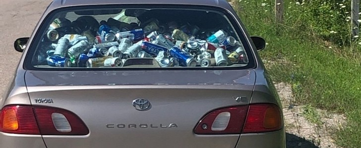 Man fills up his car with empty beer cans