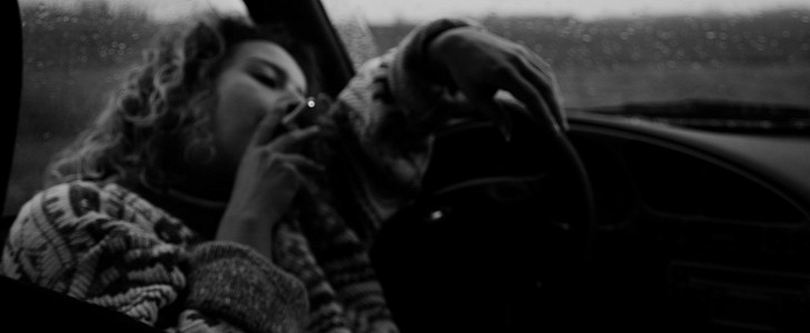 Woman smoking in car