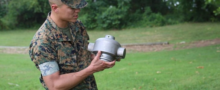 CWO2 Justin Trejo, a project officer with the Program Manager for Ammunition at Marine Corps Systems Command, displays a 3D-printed headcap for a rocket motor 