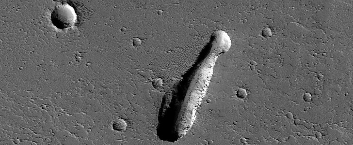 Collapse pit in the Ceraunius Fossae region of Mars