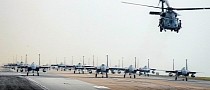 Massive Formation of F-15C/D Eagles Follow Helicopter Down the Runway