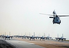 Massive Formation of F-15C/D Eagles Follow Helicopter Down the Runway
