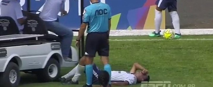 Medical cart rolls over injured footballer's foot it had come to help