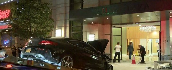 Mercedes-Benz C-Class coupe being towed out of the lobby of Trump Plaza in New Rochelle, New York