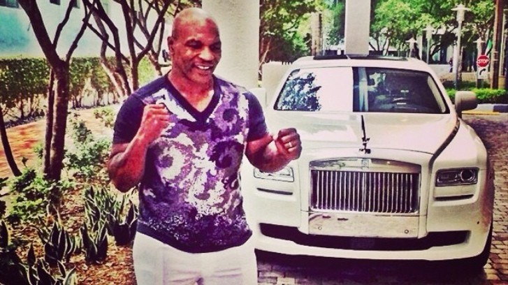 Mike Tyson next to his Rolls-Royce Ghost