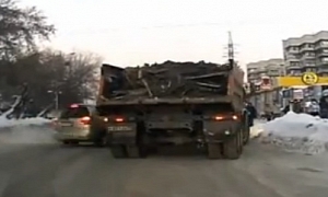 Minivan Slips, Smashes into Truck in Russia