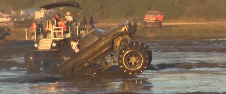 monster truck wheelstands in mud