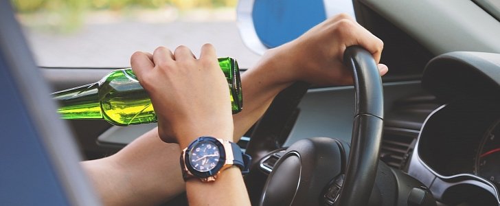 Person drinking alcohol at the wheel