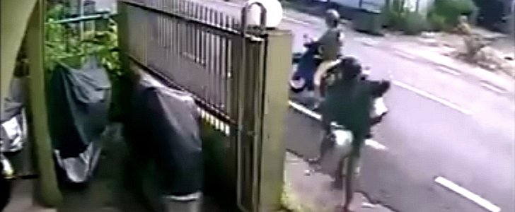 Thieves stealing car rims on a scooter