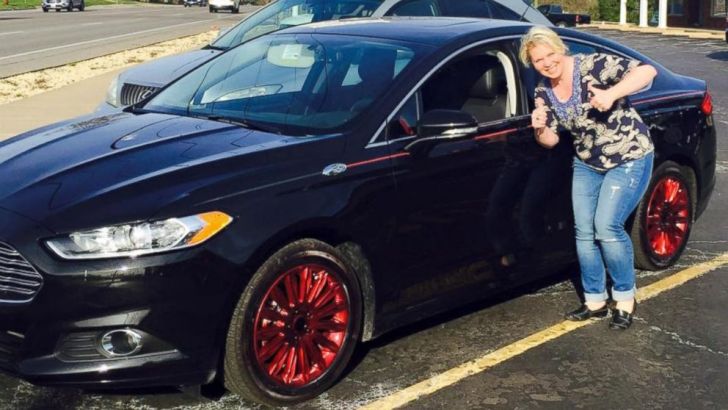 Becky Schoenig next to her 2015 Ford Fusion after she got it back