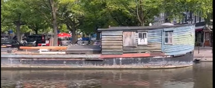 The Dogger is a historic houseboat sitting on one of Amsterdam's canals