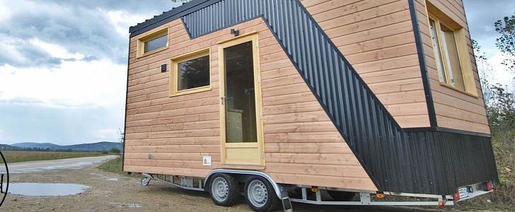 The Marie-Ange tiny house from Optinid is very rustic-looking, has trademark sliding roof