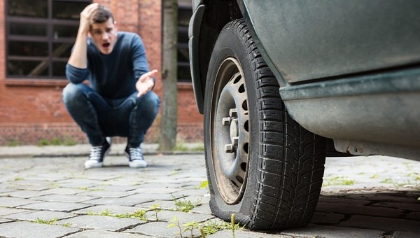 Man Worried about a Deflated Tire