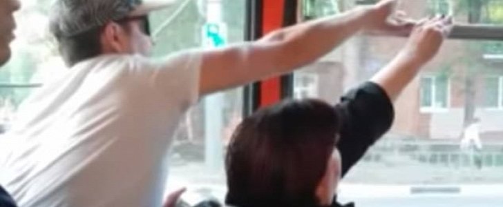 Man and woman are locked in petty and silent fight over bus window