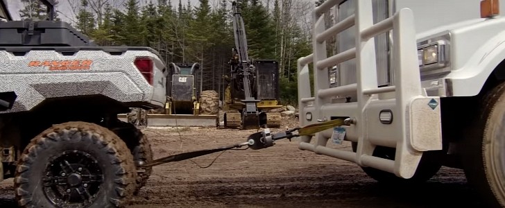 Polaris electric Ranger towing loaded logging truck