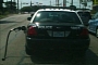 Police Car Driving with Gas Pump Nozzle: Real Photo