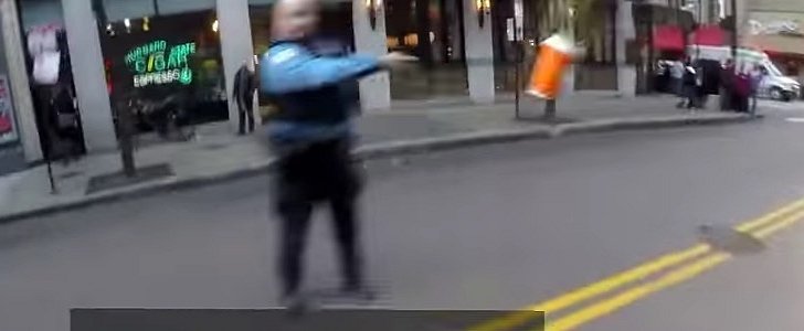 Police officer throws coffee at rider