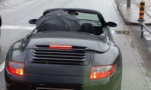 Porsche 911 Cabrio Driving with the Roof Down in the Rain Sparks Massive Debate