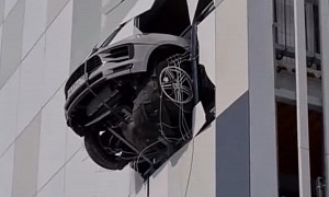 Porsche Macan Perilously "Ice Skates," Ends Up Hanging Four Stories Above Ground