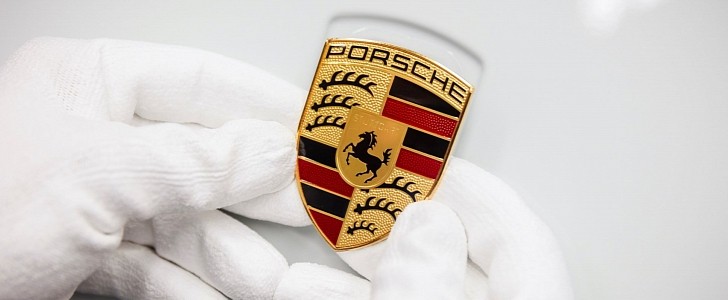 Porsche badge being placed on the hood of a vehicle