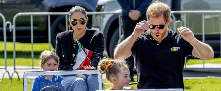 The Duke and Duchess of Sussex in electric Mini Land Rover Defenders