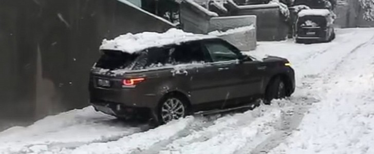 A Range Rover Sport driver trying to climb a snowy street