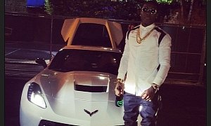 Rapper Ace Hood Poses Next to His Corvette Stingray, Holding a Champagne Bottle