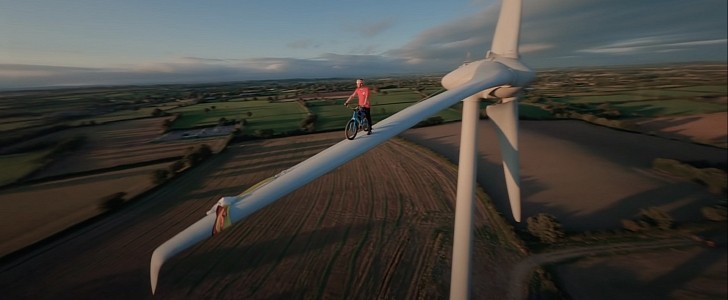 Cyclist Danny MacAskill riding his bike on the blade of a wind turbine