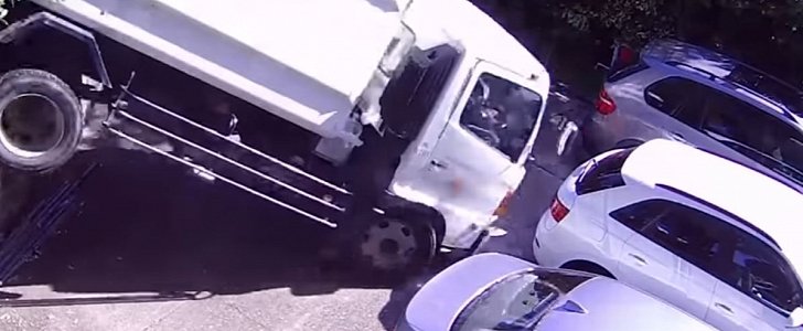 Garbage truck falls over wall, crushes 2 cars in freak accident
