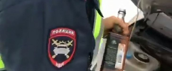 Viral video shows Russian cop using whiskey as windshield wiper fluid
