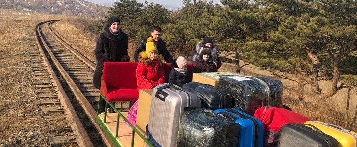 Russian diplomats ride hand-pushed trolley back home from North Korea