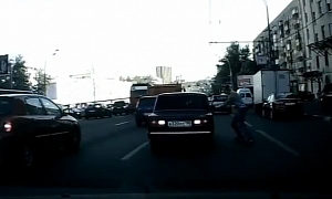 Russian Man Attempts to Board Moving Lada - Fails and Loses His Hat!